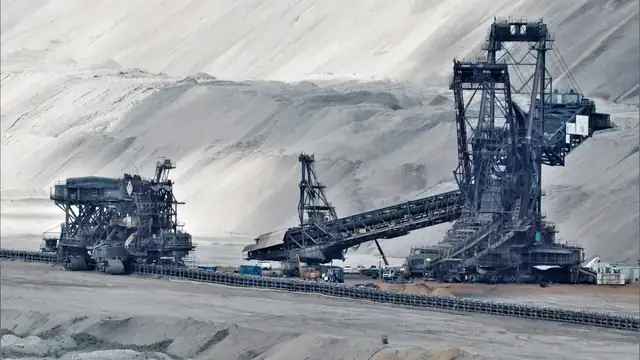 Máquina pesada opera em área de mineração a céu aberto