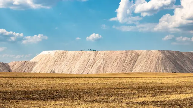 Paisagem de mineração com grande pilha de estéril sob céu claro